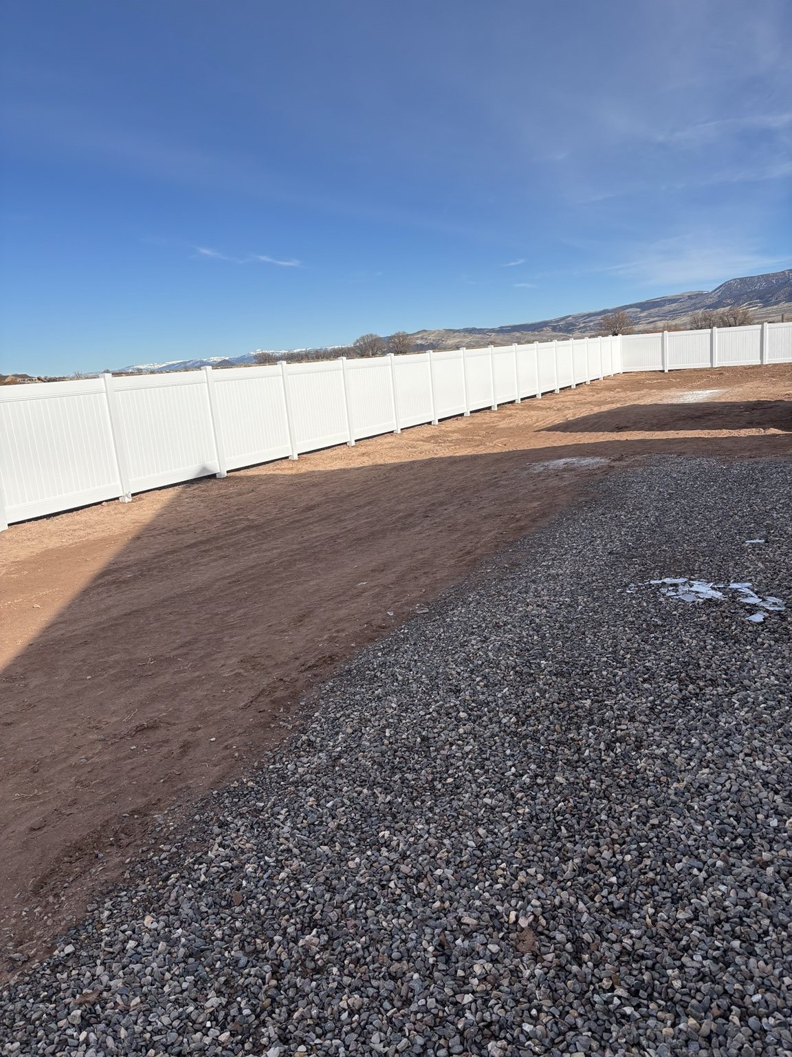 White vinyl fence around acreage